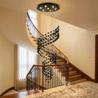 Black Obsidian Tiered Chandelier Gema hanging in luxury staircase foyer
