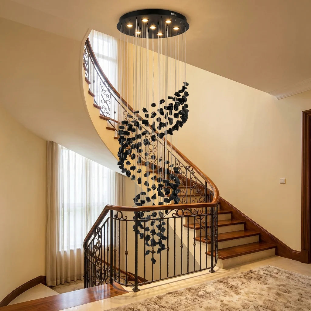 Black Obsidian Tiered Chandelier Gema hanging in luxury staircase foyer