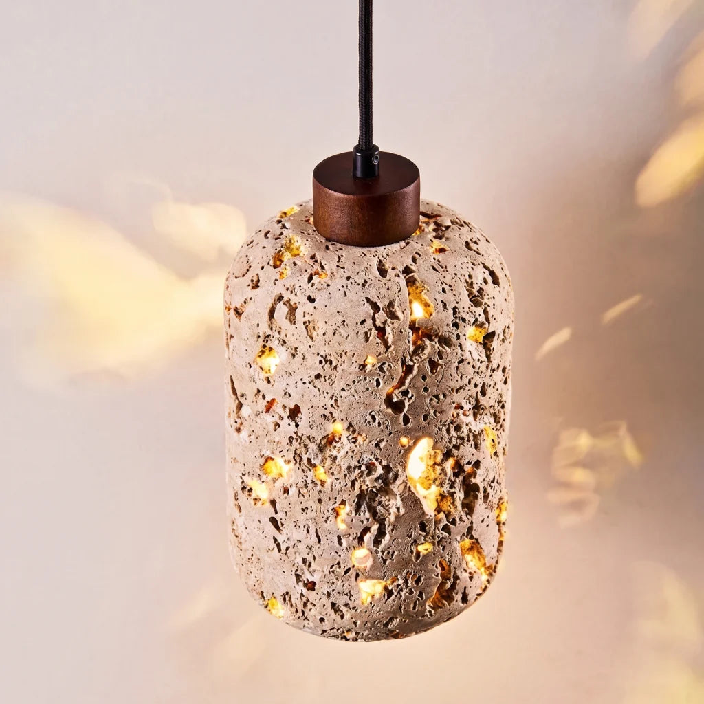 Tufa Calcified Stone Pendant Light warm ambient lighting in evening dining room setting
