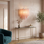 Tubular glass wall sconce beside mirror